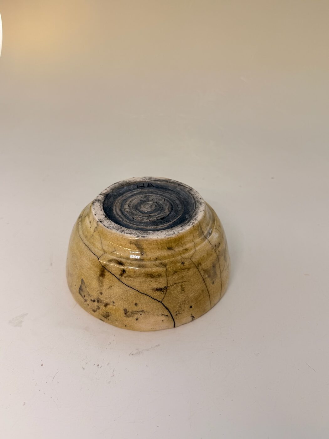 Small raku-fired bowl with crackle glaze and smoky carbon tones